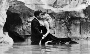 Famous kiss scene in Trevi Fountain in Rome from La Dolce Vita film by director Federico Fellini with Marcello Mastroianni and Anita Ekberg.