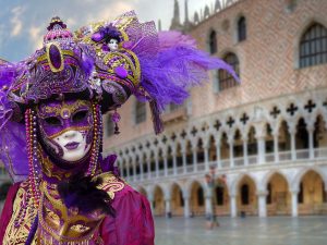 Carnevale masks and costumes in Venice in front of Doge's Palace.