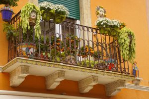 Colorful handpainted Sicilian ceramics in shape of heads, Testa di Moro. Decorate a balcony in Taormina, Sicily