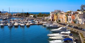 Panoramic view of the small harbor of Chiaiolella Marina. On the right are the colorful houses of fishermen.